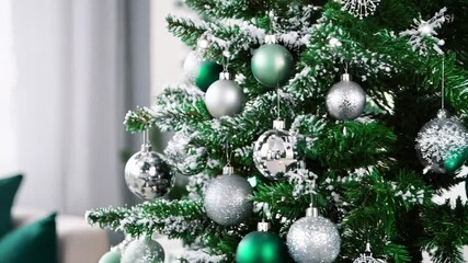 A stunning Christmas hall with a snow-covered tree, decorated in silver and green, sets a festive holiday atmosphere