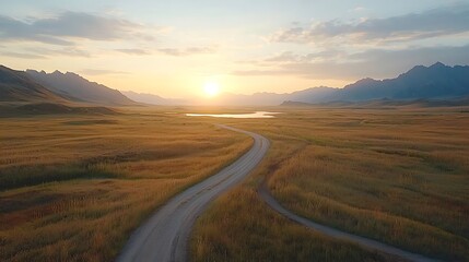 Breathtaking sunrise over serene landscape with winding road and majestic mountains in the distance