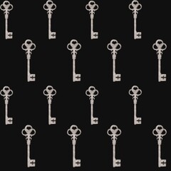 Repeating pattern of vintage keys on a dark background for design inspiration