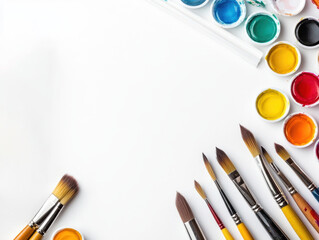 Art supplies including watercolor paints and brushes, white isolated background.