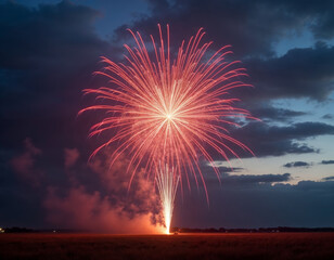 red fireworks are bursting and lighten up in the sunset sky over a field with smokes arround it