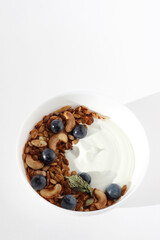 Breakfast Food. Bowl with Greek Yogurt, Nuts and Seeds Granola, Cashew Nuts, Grapes.