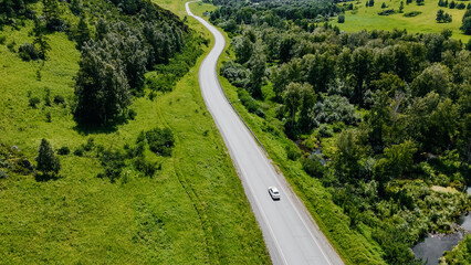 the car is driving along a mountain road in Altai