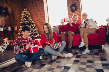 Full body portrait of big friendly family open present box xmas new year celebration flat indoors