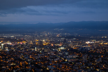 City illuminated at dusk, seen from above. The European capital of North Macedonia, Skopje.