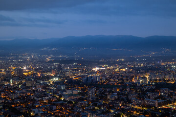 City illuminated at dusk, seen from above. The European capital of North Macedonia, Skopje.