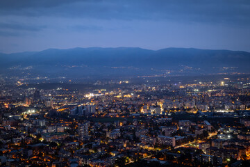 Obraz premium City illuminated at dusk, seen from above. The European capital of North Macedonia, Skopje.