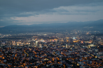 City illuminated at dusk, seen from above. The European capital of North Macedonia, Skopje.