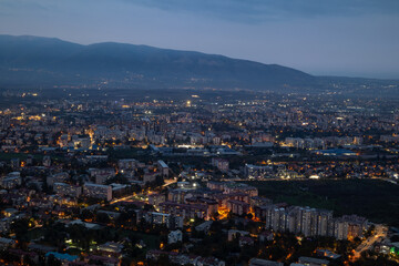 Obraz premium City illuminated at dusk, seen from above. The European capital of North Macedonia, Skopje.