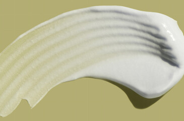 Cosmetic white cream balm thick nourishing or mask texture smudge swatch sample green olive background