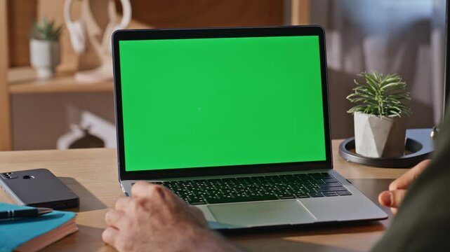 Professional hand tapping chromakey computer button at agency office closeup