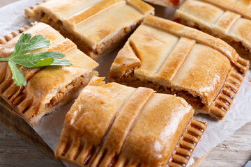 Tuna pie (empanada gallega) on wooden table. Traditional spanish food