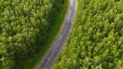 cars and trucks are driving along the highway