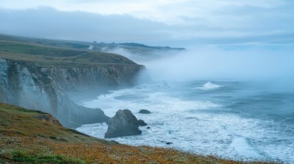 Obraz premium Dramatic Foggy Coastline with Rugged Cliffs and Waves