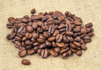 Coffee beans is on the burlap sack background