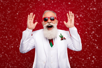 Photo of positive joyful happy man amazed shocked sale raise hands wear sunglass isolated on red color background