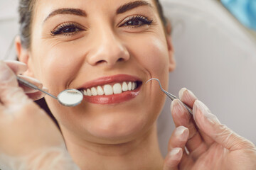 Close up portrait of a woman patient with wide smile at a dentist appointment in a hospital, doctor...