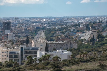 Highway cutting through dense Limassol cityscape in the daytime. Cyprus