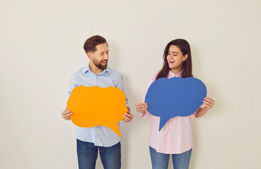Holding paper speech bubbles couple playful banter faces smiling and joy. Speech bubbles capture essence of light hearted exchanges creating moments pure delight with speech bubbles dialogues