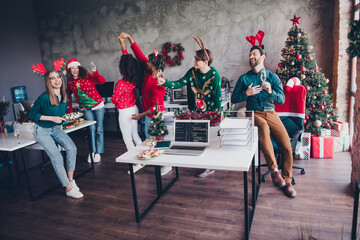 Photo of six corporate workers laugh drink champagne dancing xmas atmosphere office party indoors