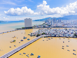 Naklejka premium The Kai River in Nha Trang.A resort town in Vietnam. October is the rainy season. The water in the river rises and turns red due to the muddy bottom and the flow of water from the mountains. 