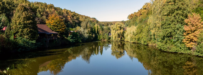 Fototapeta premium Lake panorama in the forest, autumn forest around the lake 