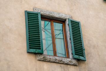 Italian style windows with green wooden shutters