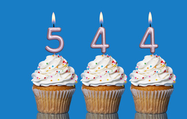 Birthday Cupcakes With Candles Lit Forming The Number 544