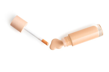 Bottle of liquid foundation and applicator on white background, top view