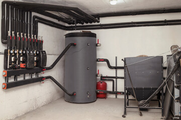 Solid Fuel Boiler with Buffer Tank Hot Water and Wood Pellet Feeder Burner in Boiler Room. Modern...