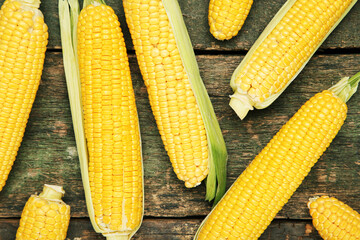 Ripe and sweet corn on wooden table