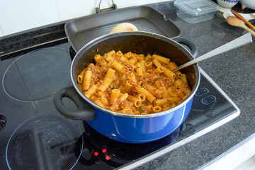 Blue pot with rigatoni bolognese