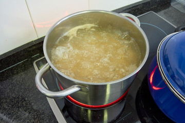 Silver pot with pasta boiling