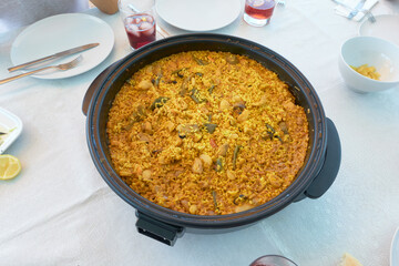Spanish paella pan ready to serve on a white tablecloth