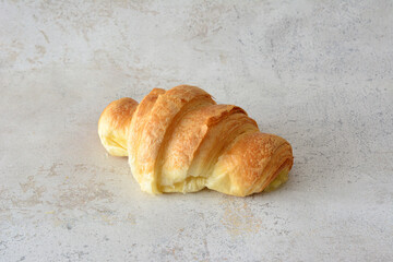 a croissant isolated on the marble background close up