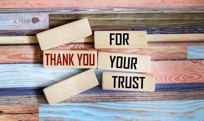 Thank you for your trust. Conceptual words Thank you for your trust on wooden blocks on a beautiful table background.