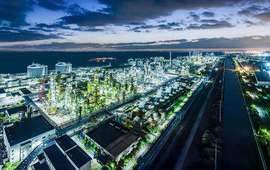 Fototapeta premium Refinery chemical plant industrial equipment in large industrial area at night
