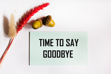 The phrase It's time to say goodbye, written in a notebook, on a white background