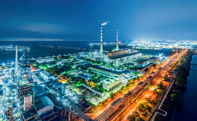 Obraz premium Refinery chemical plant industrial equipment in large industrial area at night