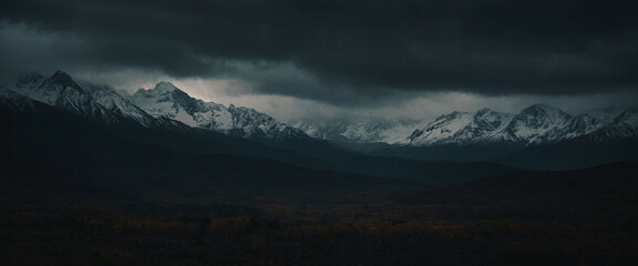 Dark clouds loom over a snow-capped mountain range