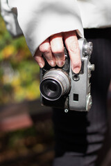 Vertical shot of  woman holding vintage camera , close up view