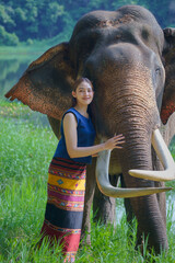 Beautiful Asian female traveler wearing Lanna Traditional Dress costume relaxes with Asian...