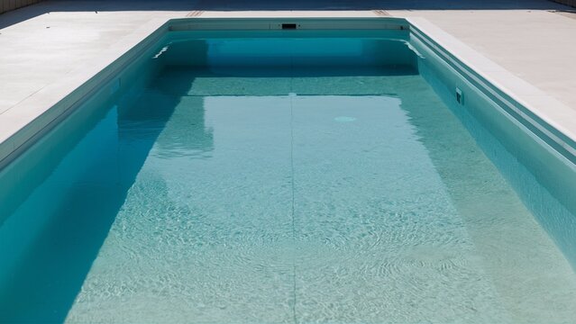 Pristine empty pool with reflective water and imma