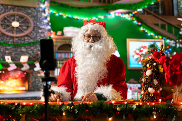Santa Claus is live streaming a video blog sharing Christmas traditions from his festive North Pole...