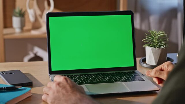 Man fingers tapping chromakey computer touchpad working cabinet agency closeup