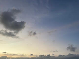 Portrait of the evening sky with clouds. A beautiful view of the natural evening sky with a background of blue, orange and white rainbow gradations