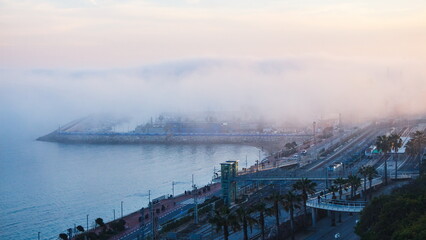 View of the city by the sea and Morning fog over the sea
