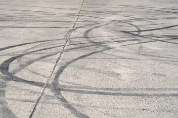 multiple tyre skid marks on concrete surface