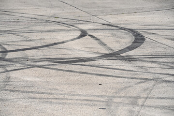 multiple tyre skid marks on concrete surface