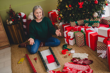 Photo of adorable cute lady wear green clothes explain how pack new year present indoors house home room